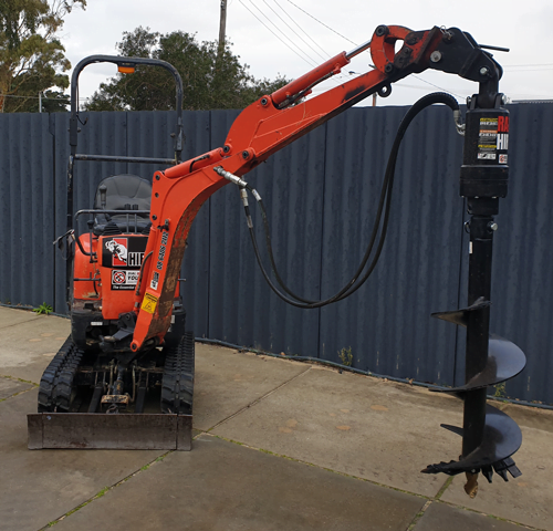 mini excavator with auger attachment fitted