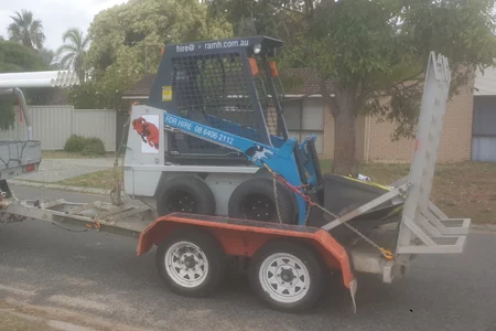 skid-steer-wet-hire Skid steer on trailer